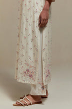 Off white silk Chanderi straight kurta set with all-over delicate embroidered flowers, highlighted with sequins and multi coloured beads.