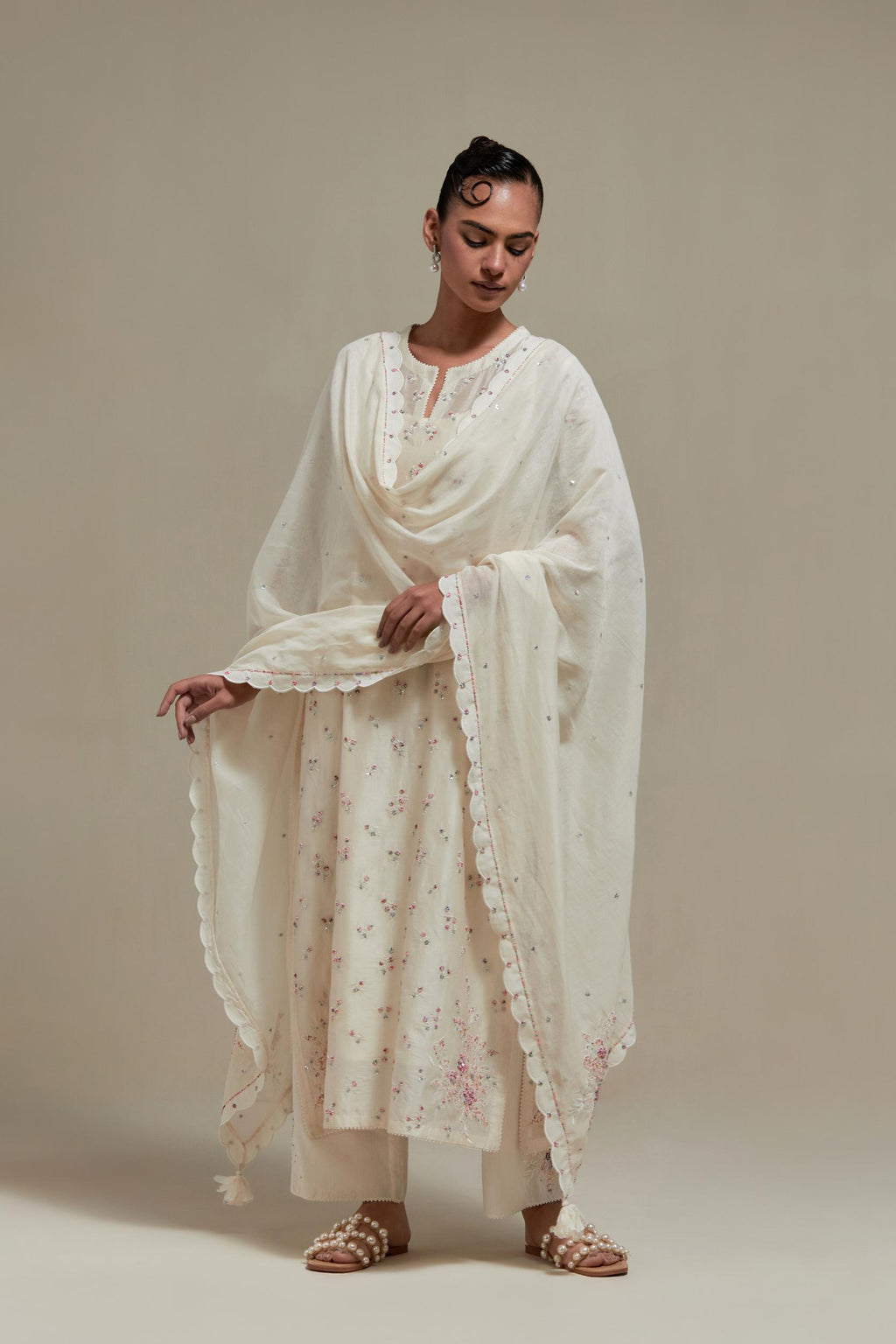 Off white silk Chanderi straight kurta set with all-over delicate embroidered flowers, highlighted with sequins and multi coloured beads.