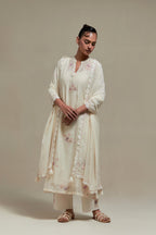Off white cotton Chanderi straight kurta set with randomly placed pink & beige hand block printed appliquéd flowers, highlighted with sequins and multi coloured beads.