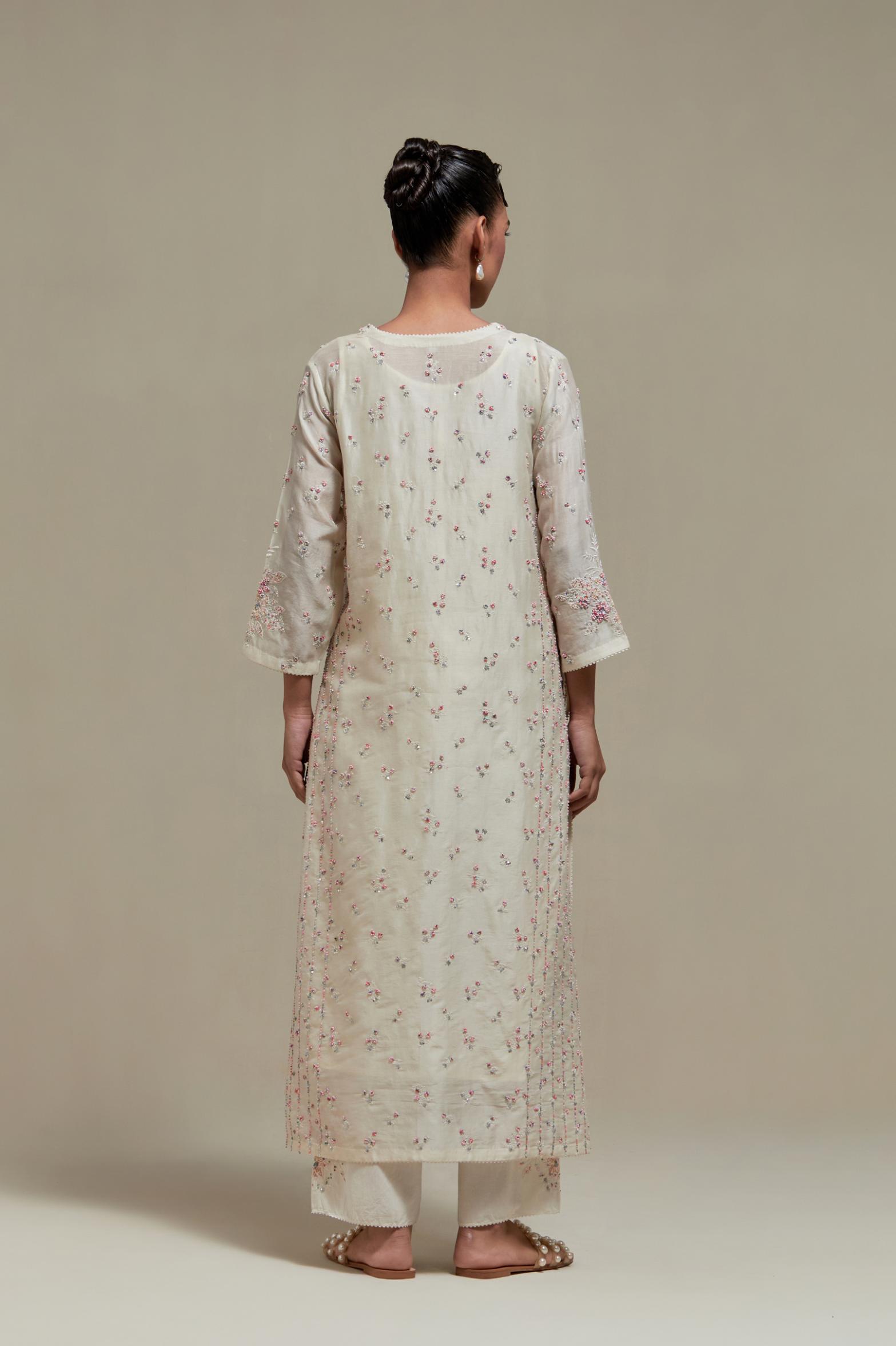 Off white silk Chanderi straight kurta set with all-over delicate embroidered flowers, highlighted with sequins and multi coloured beads.