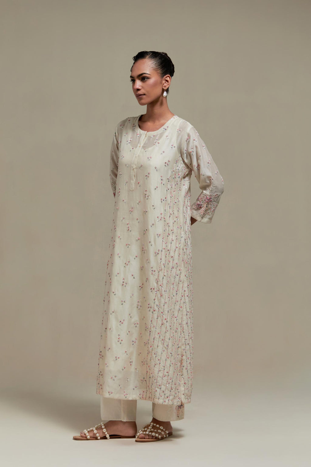 Off white silk Chanderi straight kurta set with all-over delicate embroidered flowers, highlighted with sequins and multi coloured beads.