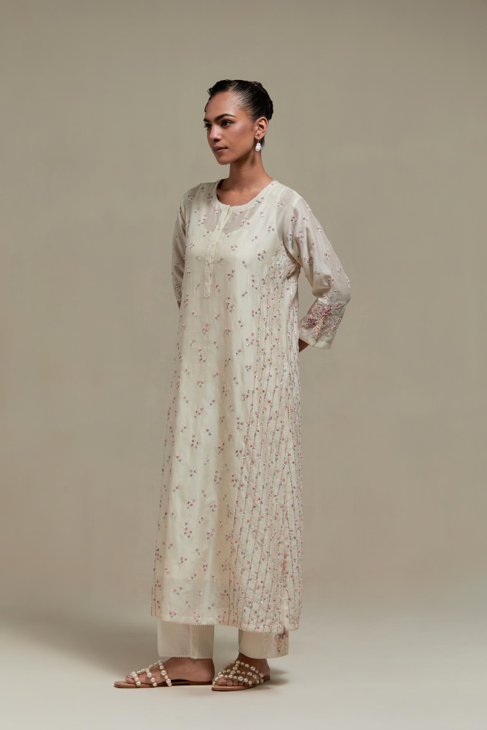 Off white silk Chanderi straight kurta set with all-over delicate embroidered flowers, highlighted with sequins and multi coloured beads.