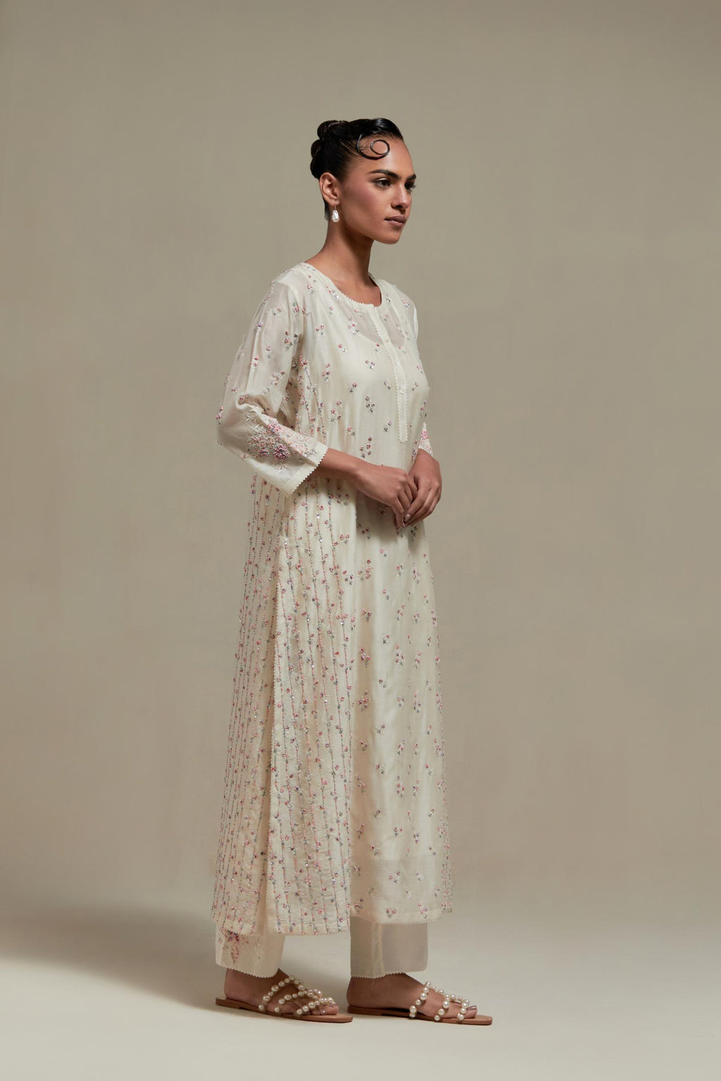 Off white silk Chanderi straight kurta set with all-over delicate embroidered flowers, highlighted with sequins and multi coloured beads.