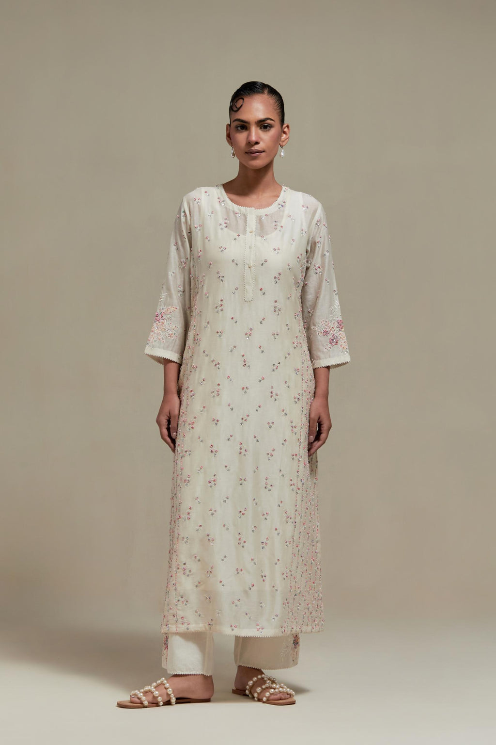 Off white silk Chanderi straight kurta set with all-over delicate embroidered flowers, highlighted with sequins and multi coloured beads.