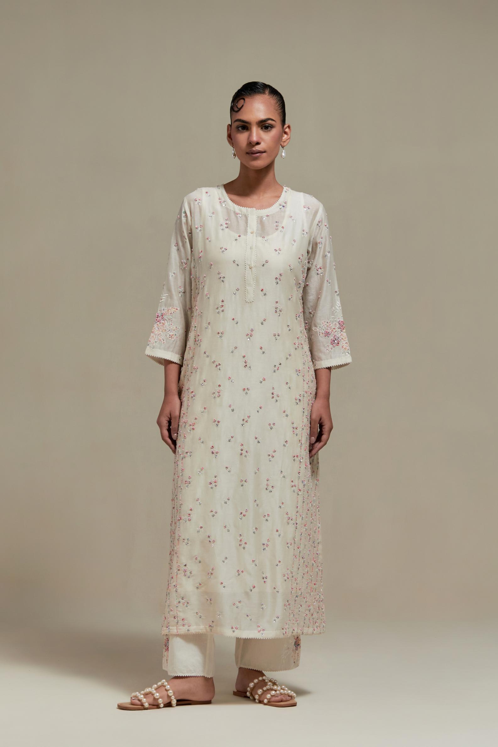 Off white silk Chanderi straight kurta set with all-over delicate embroidered flowers, highlighted with sequins and multi coloured beads.