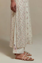 Off white silk Chanderi straight kurta set with all-over delicate embroidered flowers, highlighted with sequins and multi coloured beads.