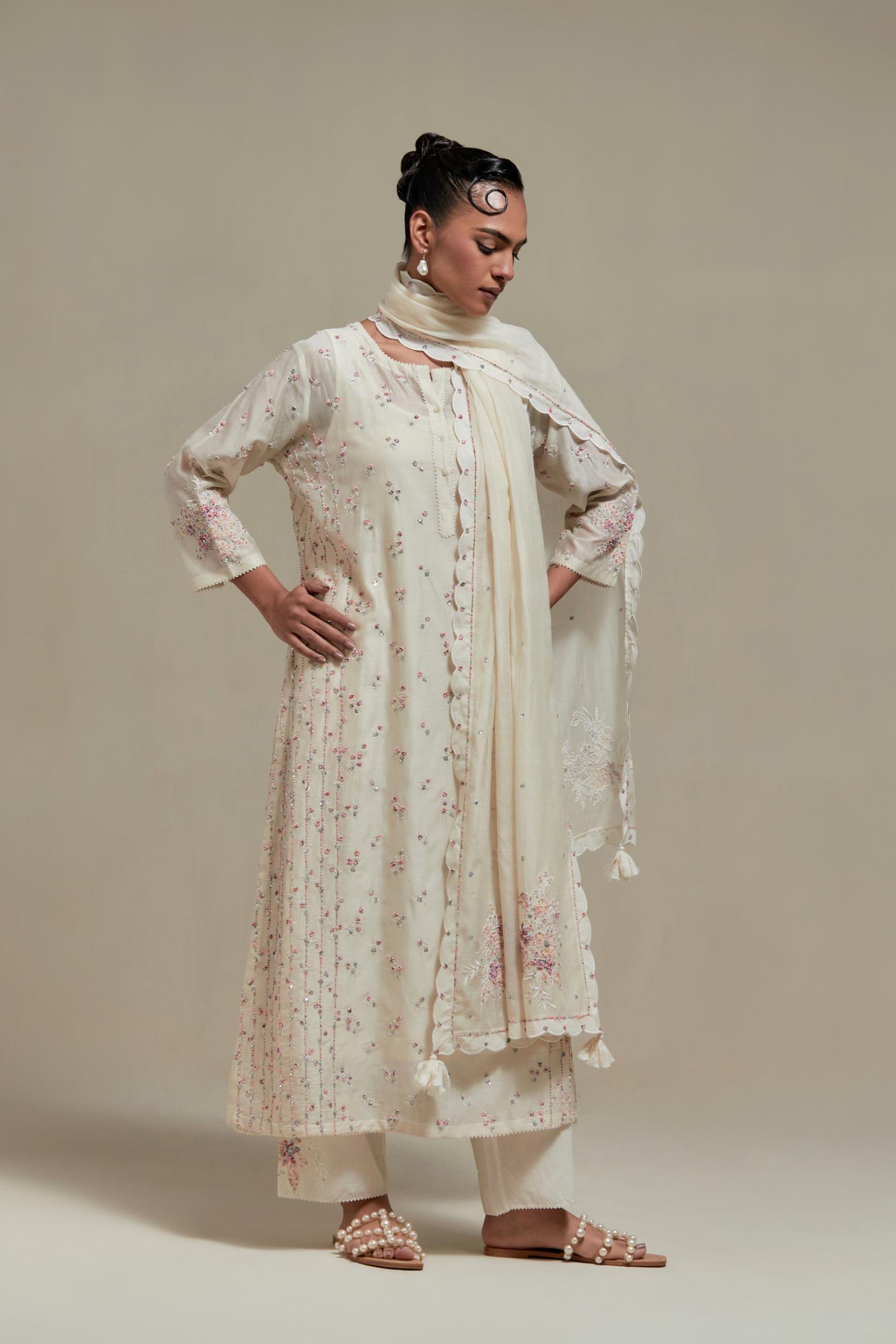 Off white silk Chanderi straight kurta set with all-over delicate embroidered flowers, highlighted with sequins and multi coloured beads.