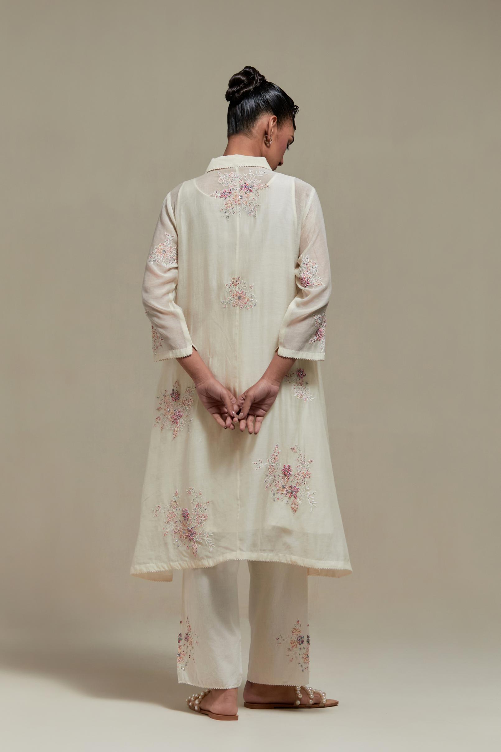 Off white cotton Chanderi short shirt-kurta set with all-over pink & beige hand block printed appliqué flowers, highlighted with sequins and multi-coloured beads.