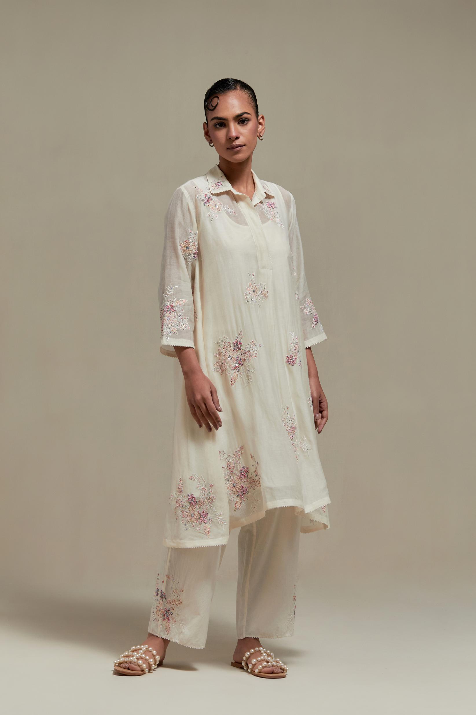 Off white cotton Chanderi short shirt-kurta set with all-over pink & beige hand block printed appliqué flowers, highlighted with sequins and multi-coloured beads.