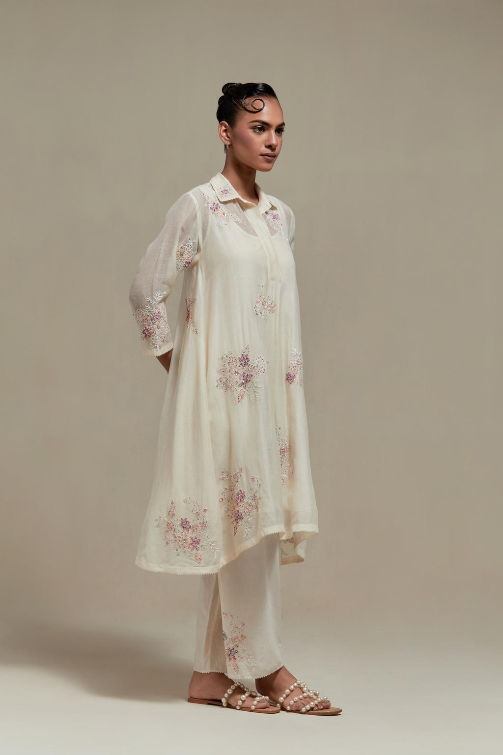 Off white cotton Chanderi short shirt-kurta set with all-over pink & beige hand block printed appliqué flowers, highlighted with sequins and multi-coloured beads.