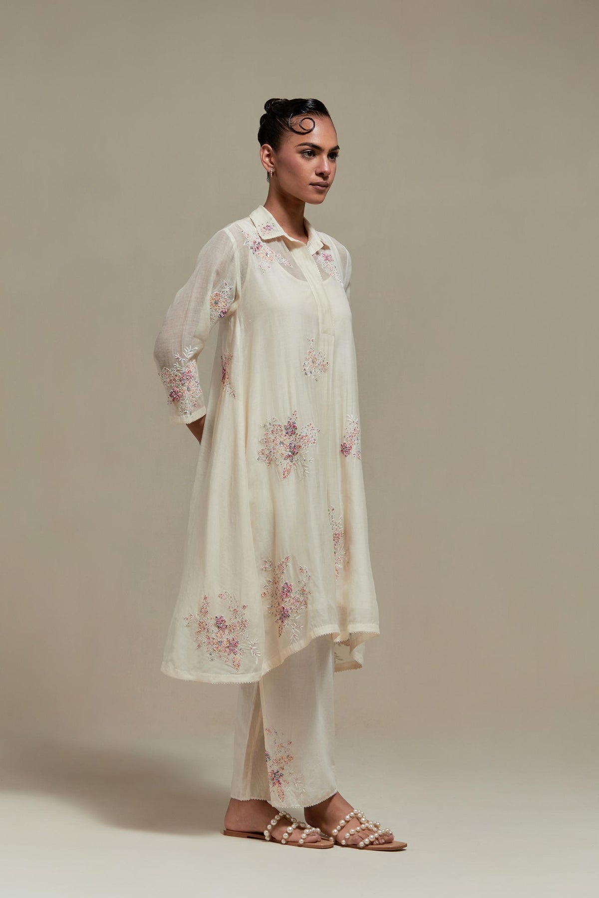Off white cotton Chanderi short shirt-kurta set with all-over pink & beige hand block printed appliqué flowers, highlighted with sequins and multi-coloured beads.