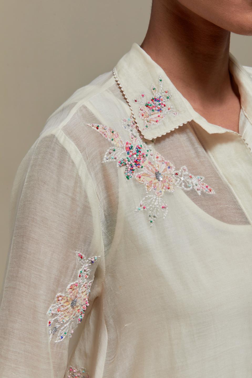 Off white cotton Chanderi short shirt-kurta set with all-over pink & beige hand block printed appliqué flowers, highlighted with sequins and multi-coloured beads.