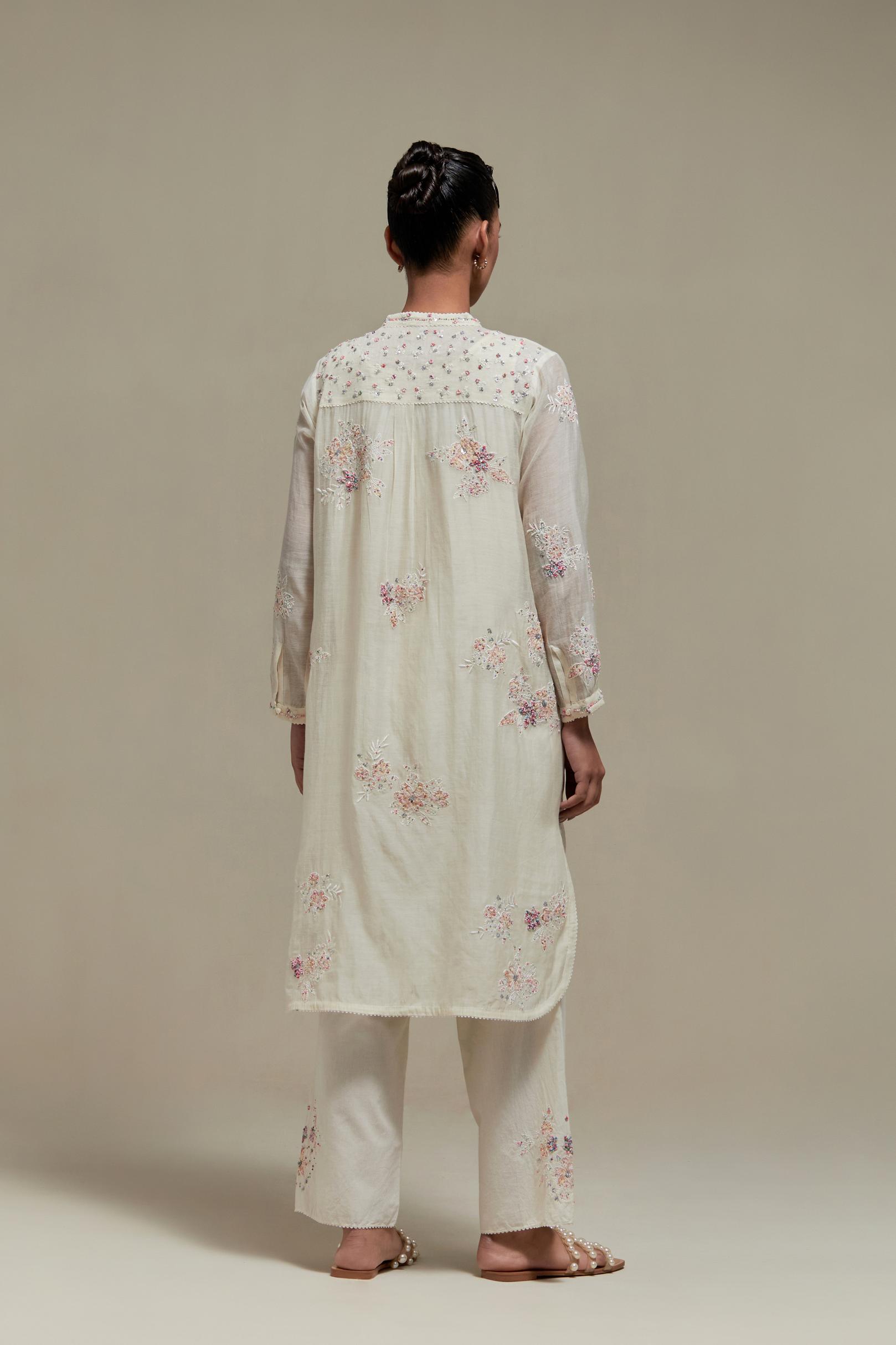 Off white cotton Chanderi short kurta set with all-over pink & beige hand block printed appliqué, highlighted with sequins and multi coloured beads.