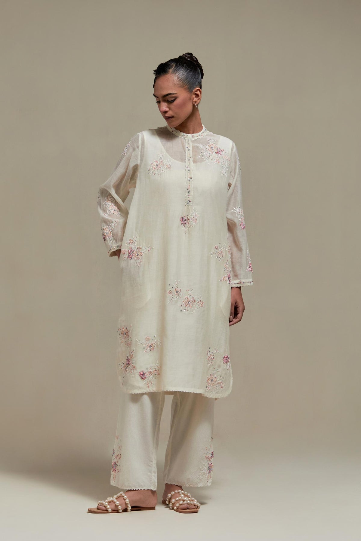 Off white cotton Chanderi short kurta set with all-over pink & beige hand block printed appliqué, highlighted with sequins and multi coloured beads.