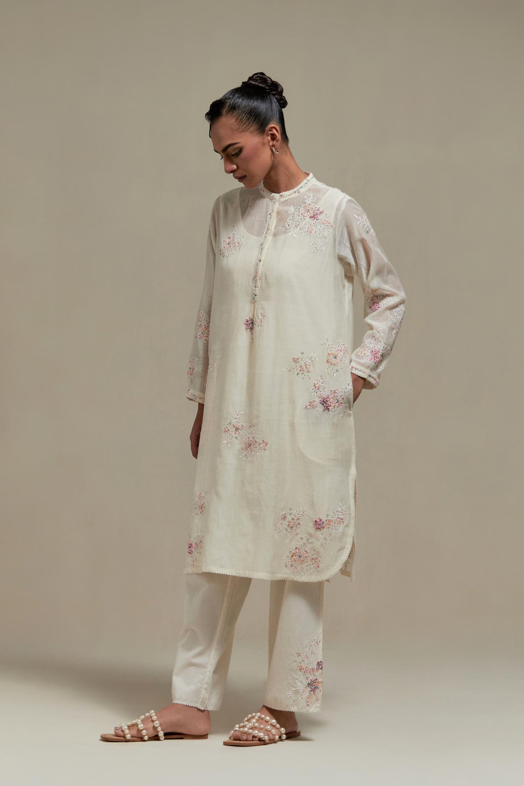 Off white cotton Chanderi short kurta set with all-over pink & beige hand block printed appliqué, highlighted with sequins and multi coloured beads.
