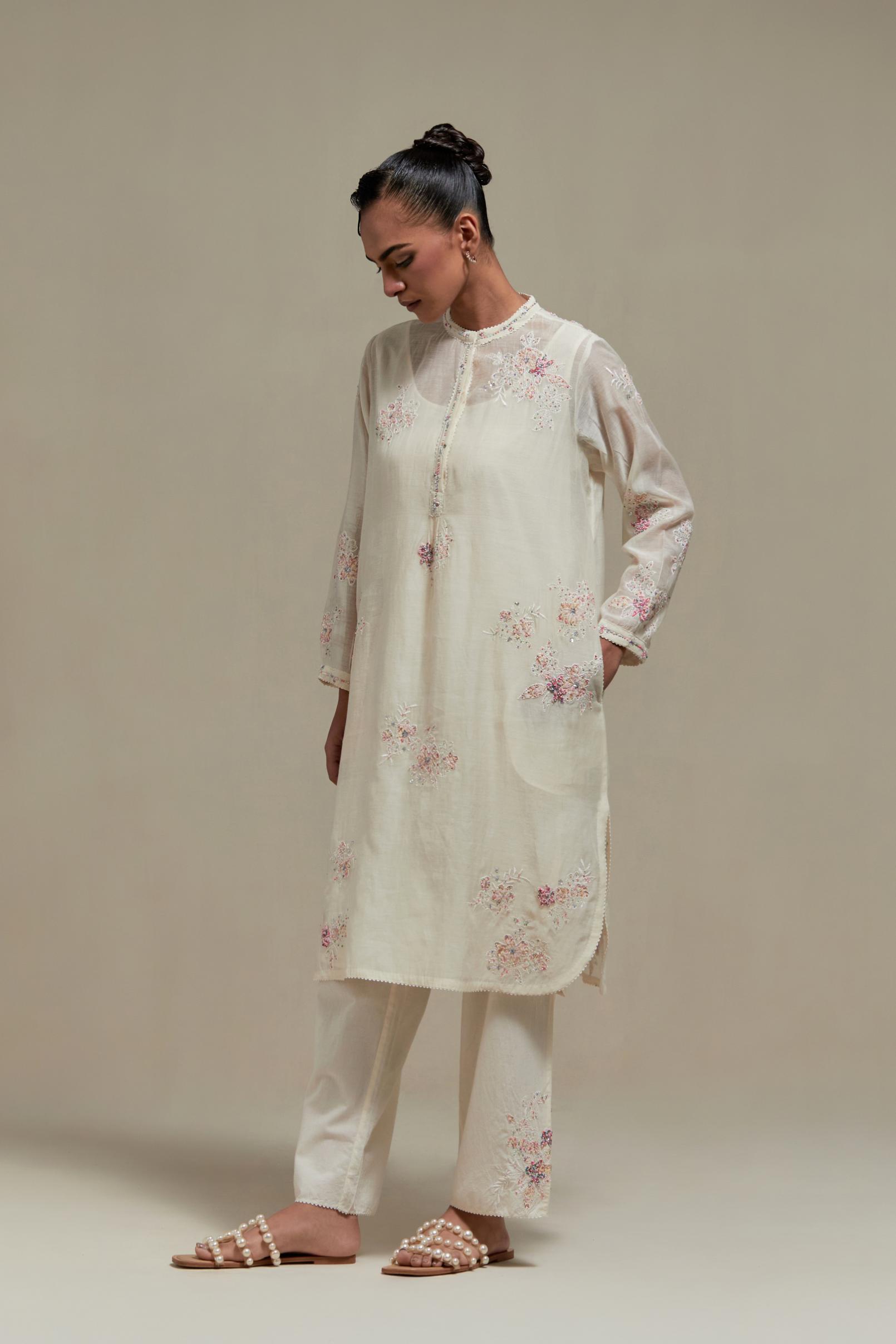 Off white cotton Chanderi short kurta set with all-over pink & beige hand block printed appliqué, highlighted with sequins and multi coloured beads.