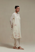 Off white cotton Chanderi short kurta set with all-over pink & beige hand block printed appliqué, highlighted with sequins and multi coloured beads.