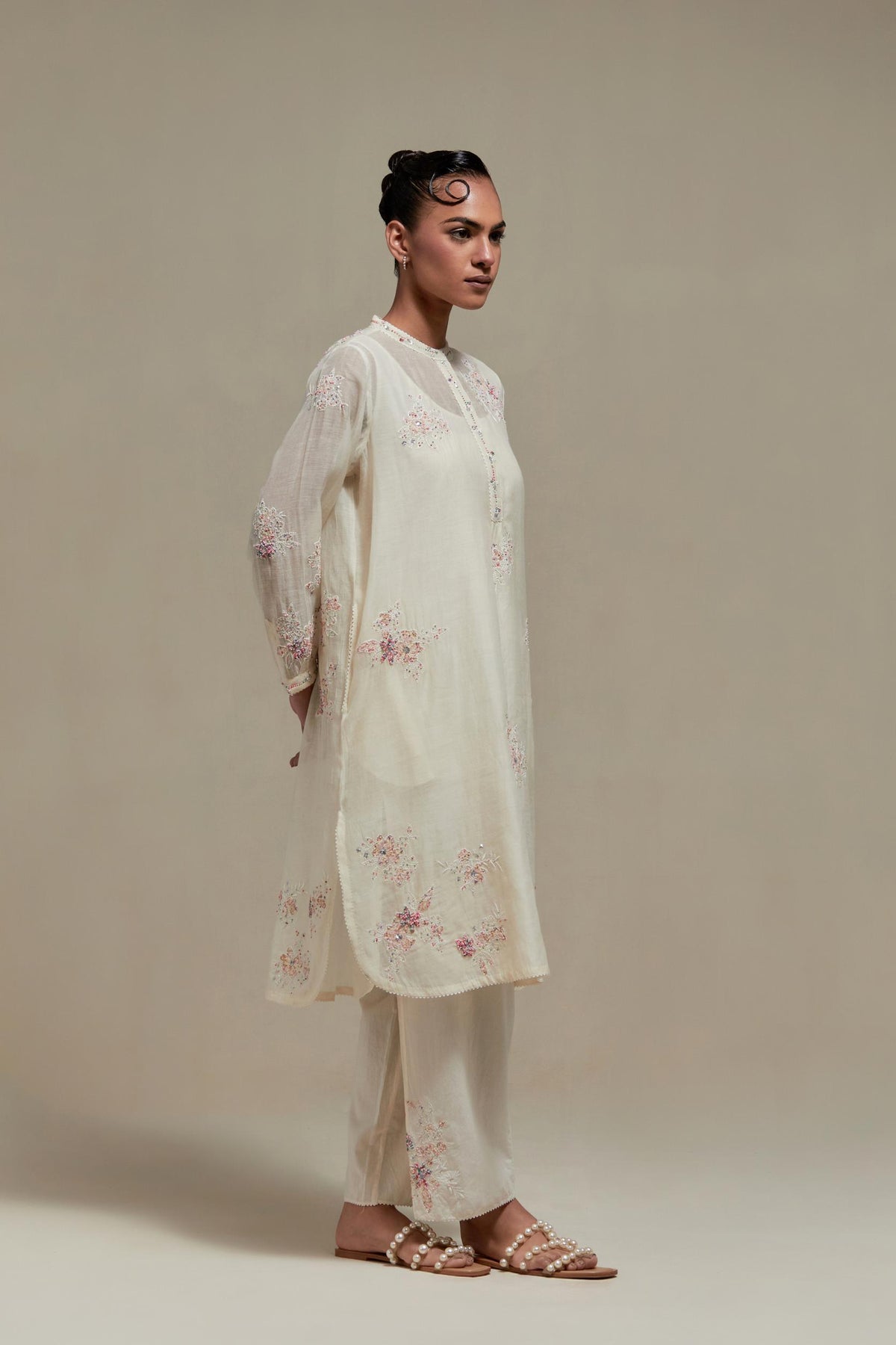 Off white cotton Chanderi short kurta set with all-over pink & beige hand block printed appliqué, highlighted with sequins and multi coloured beads.