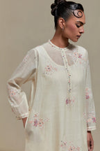 Off white cotton Chanderi short kurta set with all-over pink & beige hand block printed appliqué, highlighted with sequins and multi coloured beads.