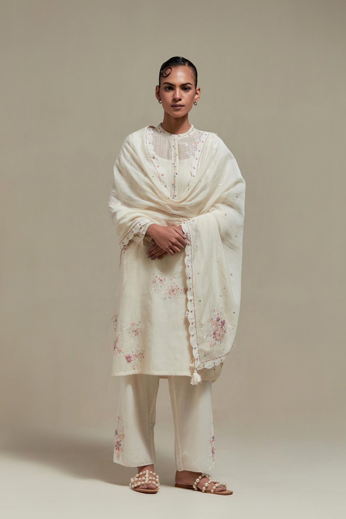 Off white cotton Chanderi short kurta set with all-over pink & beige hand block printed appliqué, highlighted with sequins and multi coloured beads.