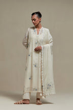 Off white cotton Chanderi dupatta, highlighted with all-over delicate sequins flower and blue & beige hand block printed appliqué motifs at dupatta corners.