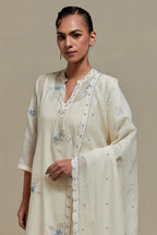 Off white cotton Chanderi dupatta, highlighted with all-over delicate sequins flower and blue & beige hand block printed appliqué motifs at dupatta corners.