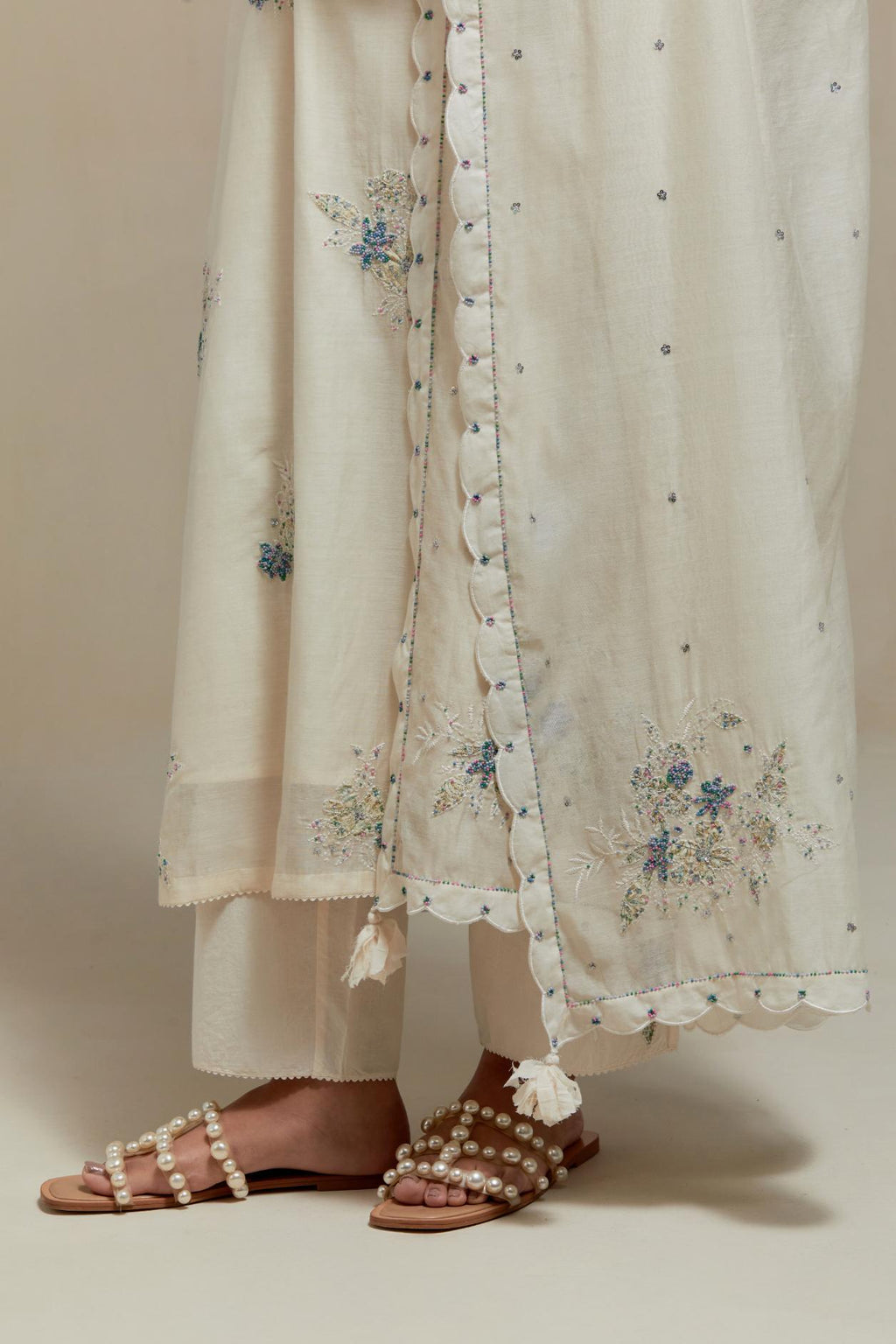 Off white cotton Chanderi dupatta, highlighted with all-over delicate sequins flower and blue & beige hand block printed appliqué motifs at dupatta corners.