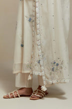 Off white cotton Chanderi dupatta, highlighted with all-over delicate sequins flower and blue & beige hand block printed appliqué motifs at dupatta corners.