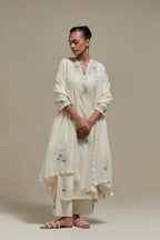 Off white cotton Chanderi dupatta, highlighted with all-over delicate sequins flower and blue & beige hand block printed appliqué motifs at dupatta corners.