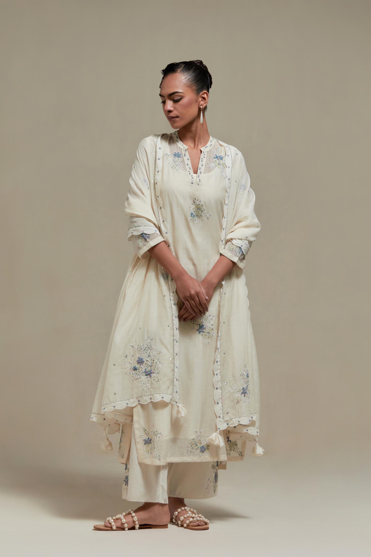 Off white cotton Chanderi dupatta, highlighted with all-over delicate sequins flower and blue & beige hand block printed appliqué motifs at dupatta corners.