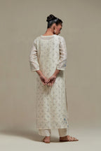 Off white silk Chanderi straight kurta set with all-over delicate embroidered flowers, highlighted with sequins and multi coloured beads.