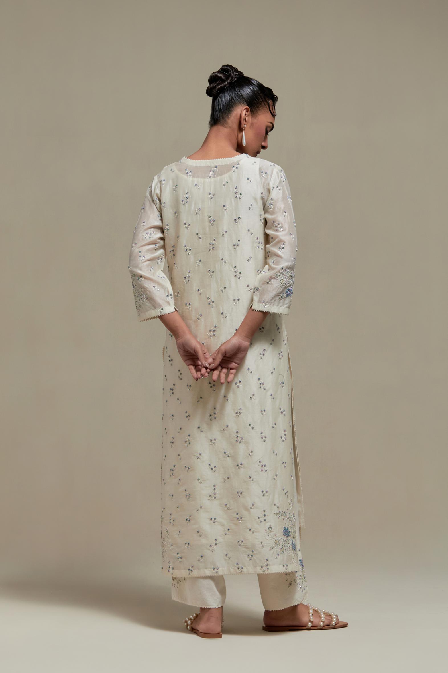 Off white silk Chanderi straight kurta set with all-over delicate embroidered flowers, highlighted with sequins and multi coloured beads.