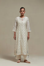 Off white silk Chanderi straight kurta set with all-over delicate embroidered flowers, highlighted with sequins and multi coloured beads.