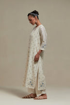 Off white silk Chanderi straight kurta set with all-over delicate embroidered flowers, highlighted with sequins and multi coloured beads.