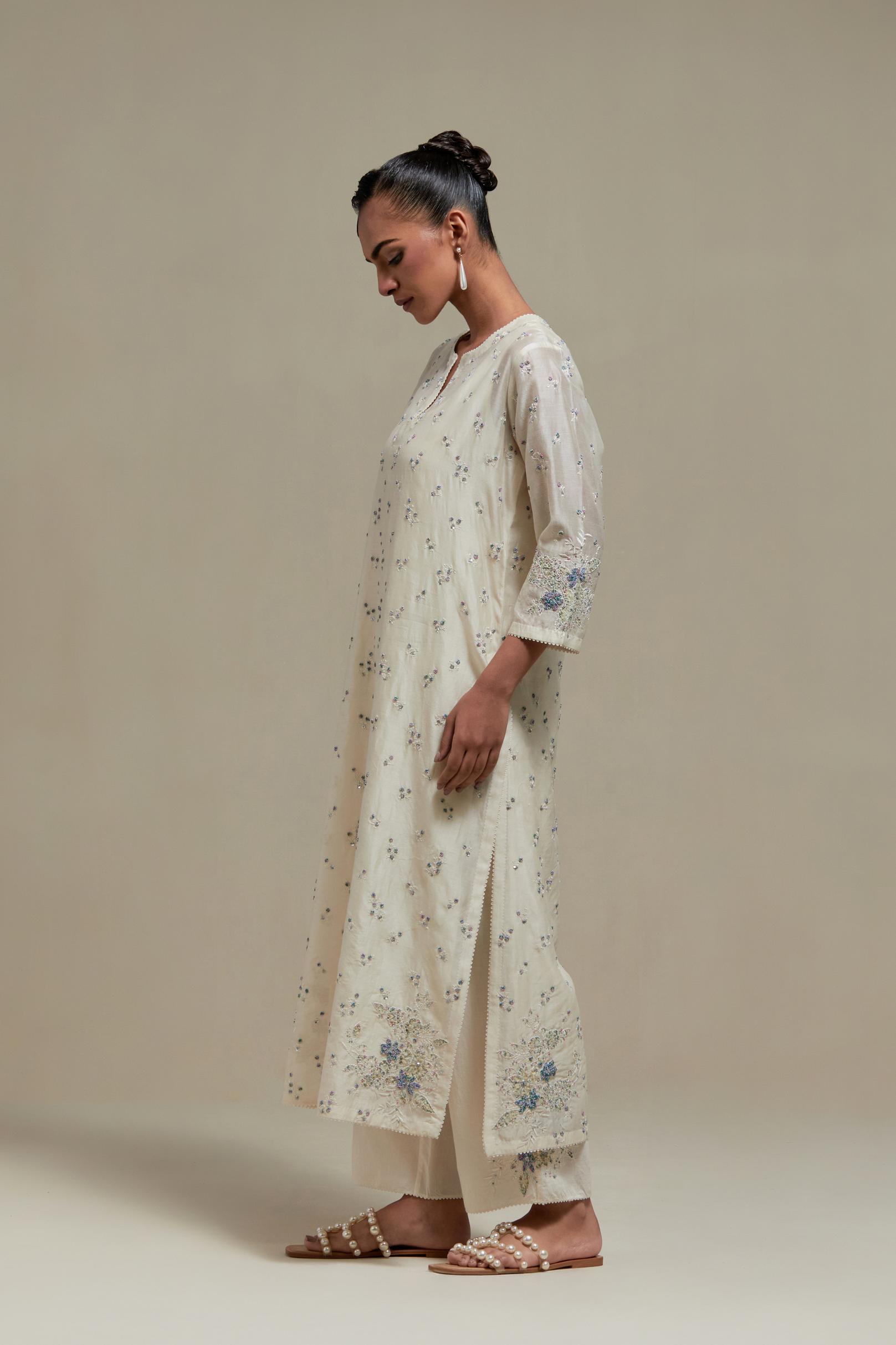 Off white silk Chanderi straight kurta set with all-over delicate embroidered flowers, highlighted with sequins and multi coloured beads.