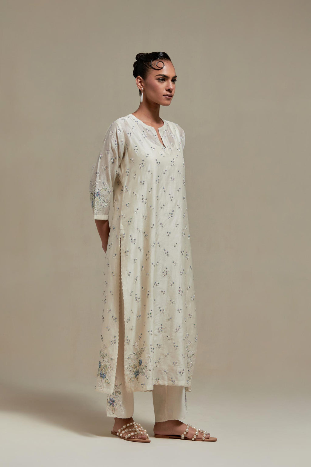 Off white silk Chanderi straight kurta set with all-over delicate embroidered flowers, highlighted with sequins and multi coloured beads.