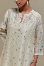 Off white silk Chanderi straight kurta set with all-over delicate embroidered flowers, highlighted with sequins and multi coloured beads.