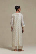 Off white silk Chanderi straight kurta set with all-over delicate embroidered flowers, highlighted with sequins and multi coloured beads.