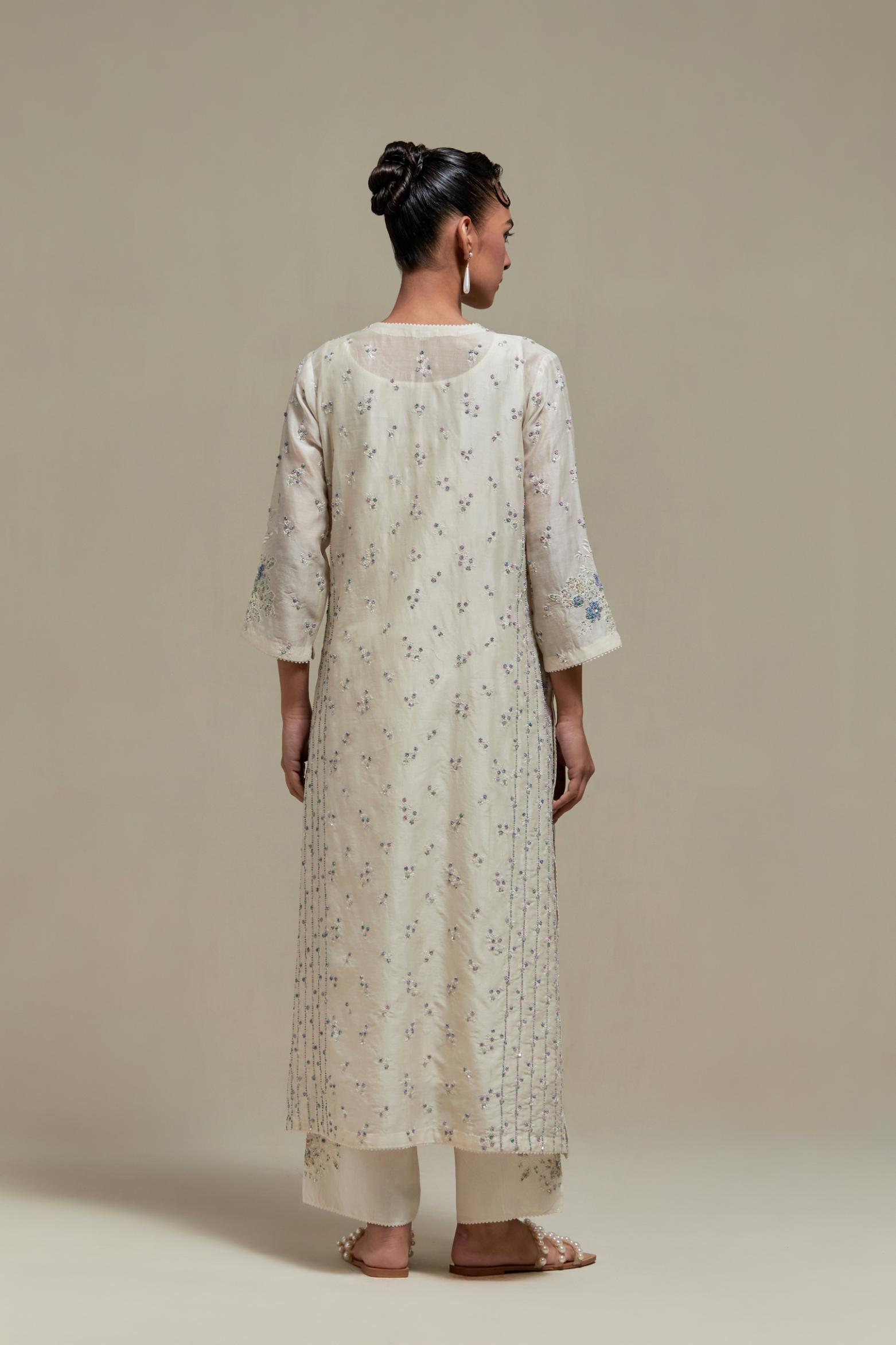Off white silk Chanderi straight kurta set with all-over delicate embroidered flowers, highlighted with sequins and multi coloured beads.