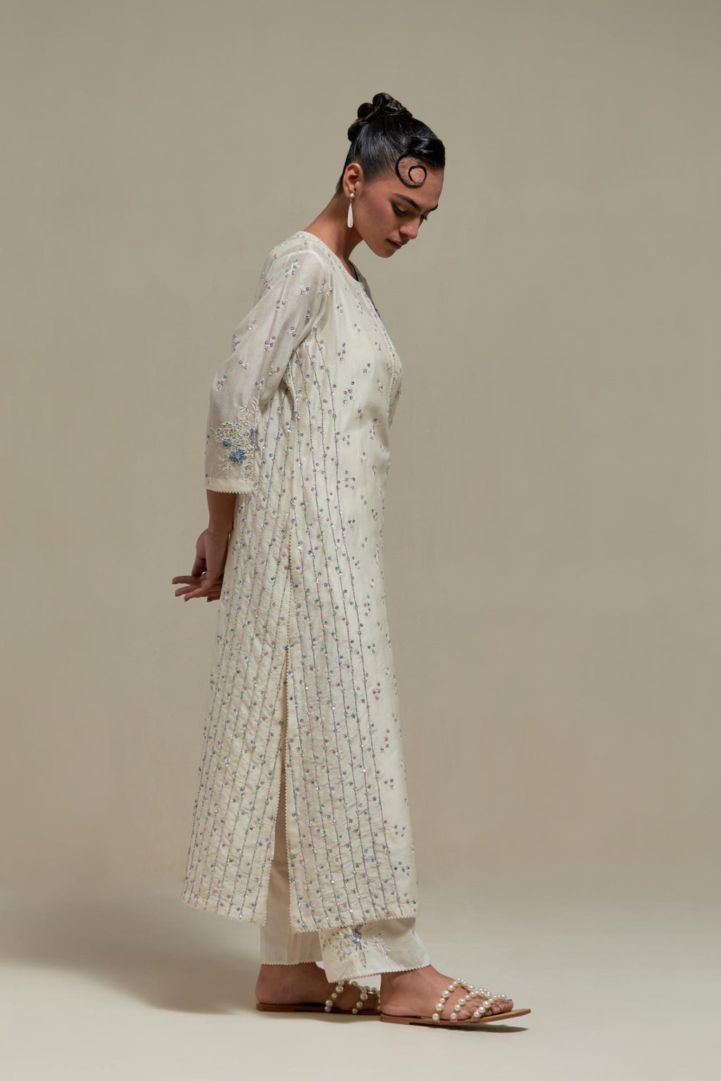 Off white silk Chanderi straight kurta set with all-over delicate embroidered flowers, highlighted with sequins and multi coloured beads.