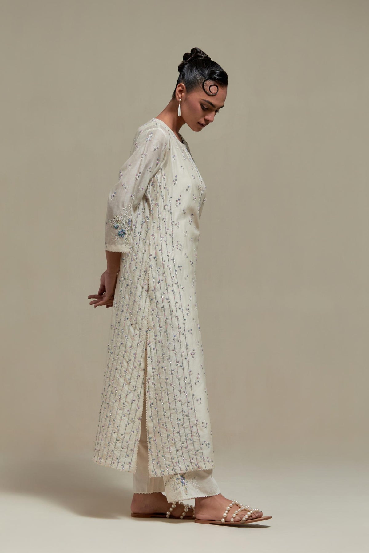 Off white silk Chanderi straight kurta set with all-over delicate embroidered flowers, highlighted with sequins and multi coloured beads.