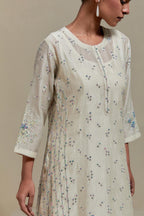 Off white silk Chanderi straight kurta set with all-over delicate embroidered flowers, highlighted with sequins and multi coloured beads.