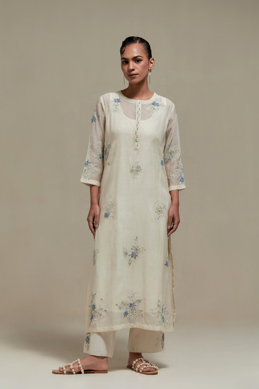 Off white straight kurta set with all-over blue & beige hand block printed appliqué motifs, highlighted with sequins and multi coloured beads.