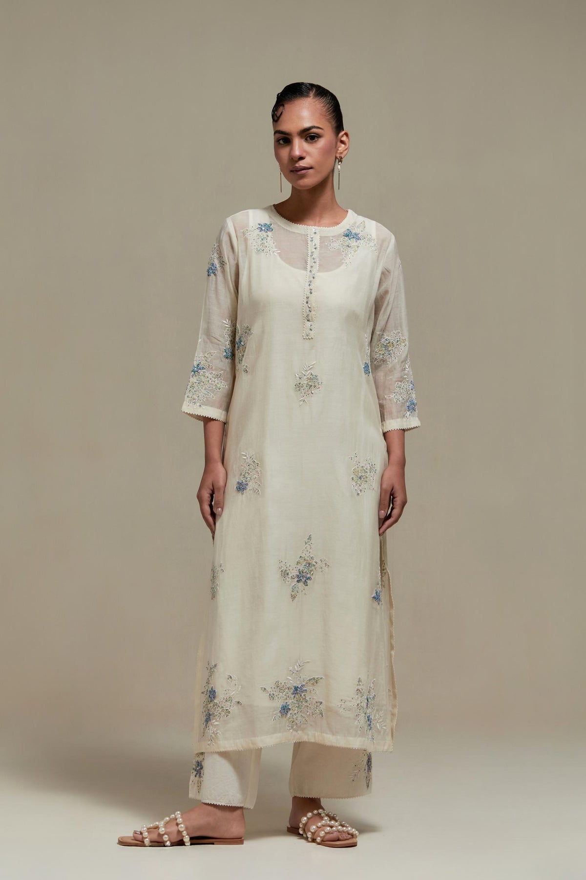 Off white straight kurta set with all-over blue & beige hand block printed appliqué motifs, highlighted with sequins and multi coloured beads.