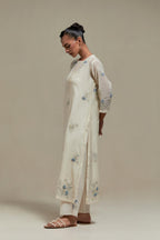 Off white straight kurta set with all-over blue & beige hand block printed appliqué motifs, highlighted with sequins and multi coloured beads.