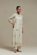 Off white straight kurta set with all-over blue & beige hand block printed appliqué motifs, highlighted with sequins and multi coloured beads.