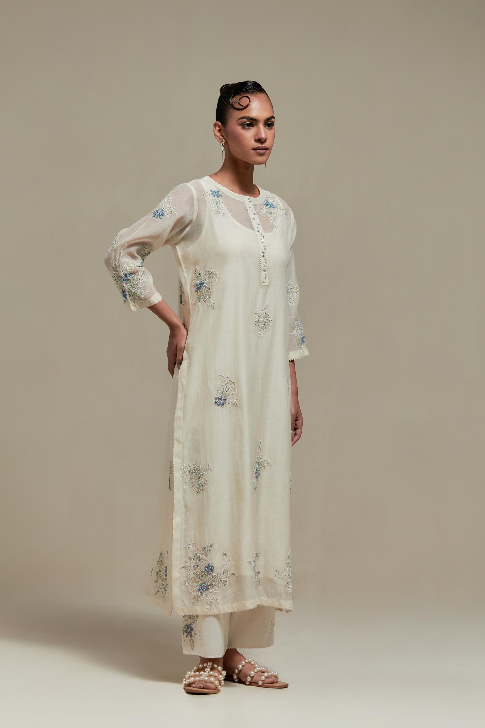Off white straight kurta set with all-over blue & beige hand block printed appliqué motifs, highlighted with sequins and multi coloured beads.