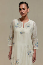 Off white cotton Chanderi straight kurta set with randomly placed blue & beige hand block printed appliquéd flowers, highlighted with sequins and multi colored beads.