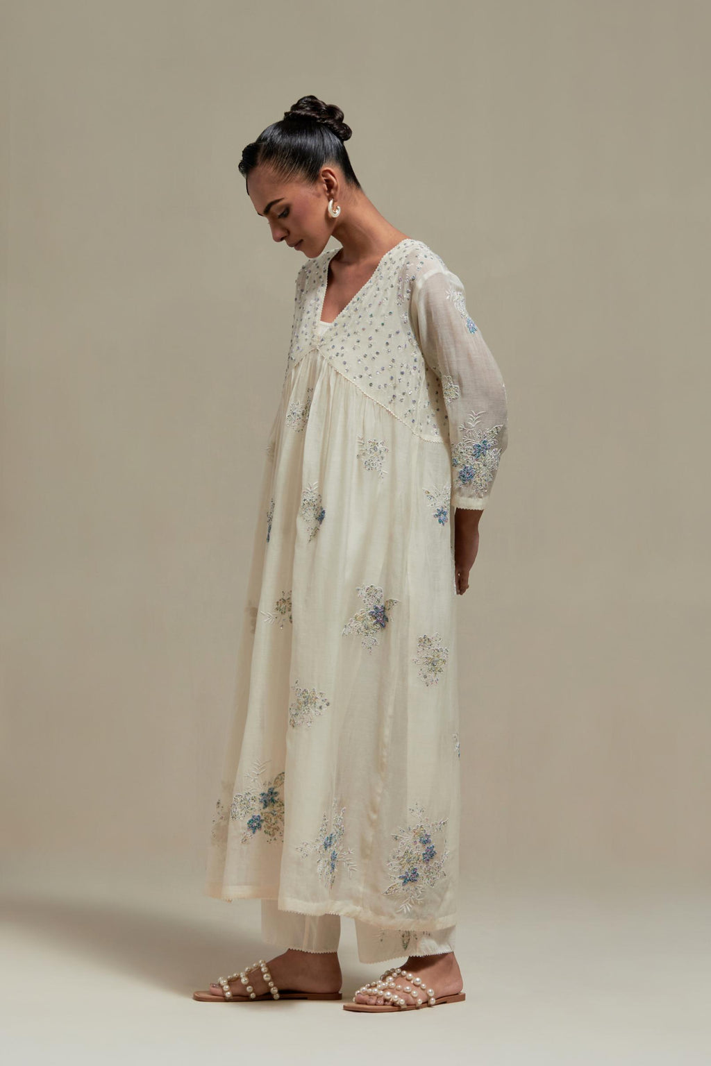 Off white cotton Chanderi kurta dress set with delicate embroidered flowers and blue & beige hand block printed appliqué motifs, highlighted with sequins and multi coloured beads.