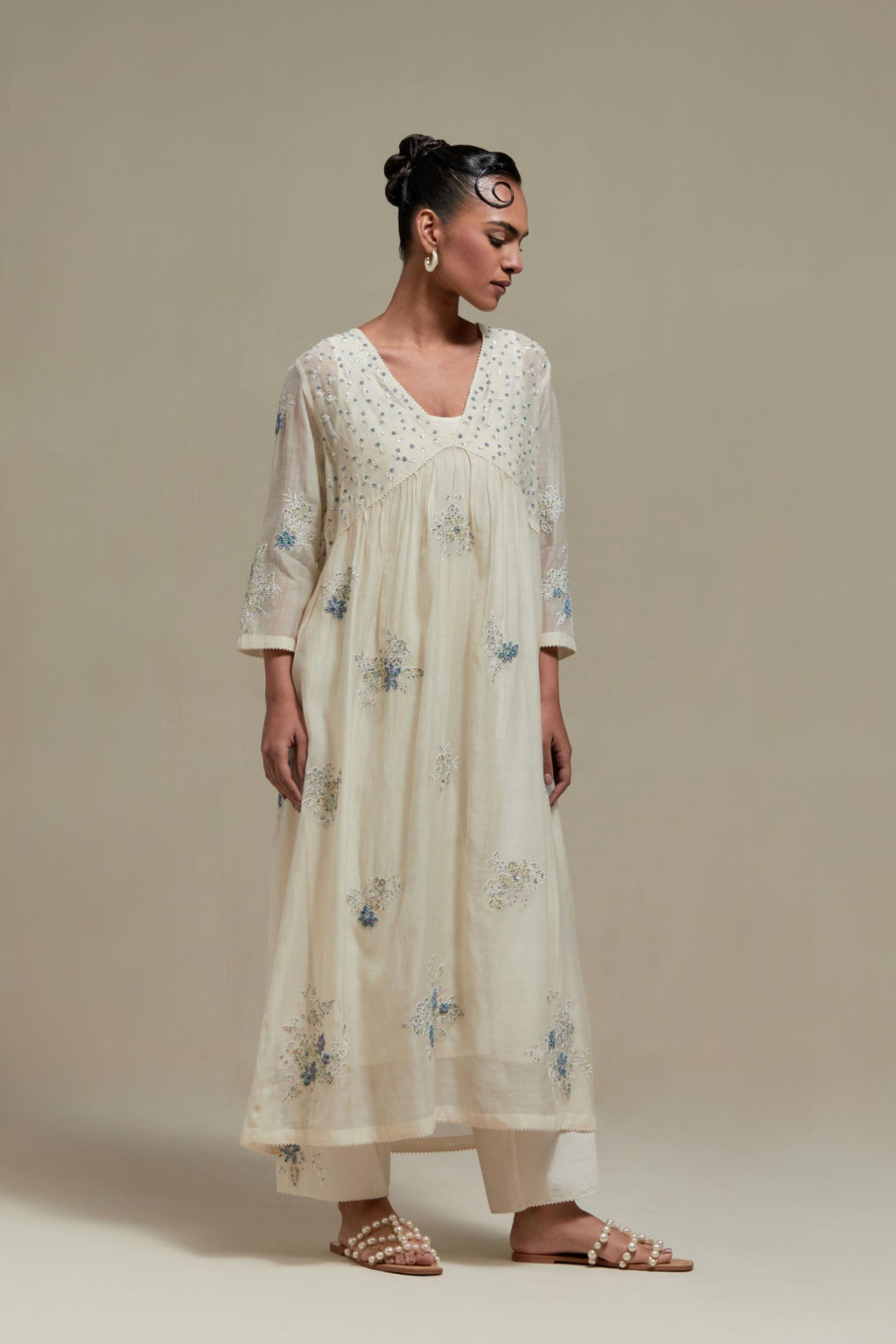 Off white cotton Chanderi kurta dress set with delicate embroidered flowers and blue & beige hand block printed appliqué motifs, highlighted with sequins and multi coloured beads.
